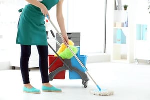 How To Choose From 7 Key Types Of Tile For Your Business woman cleaning floor in office