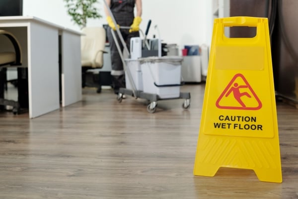 caution-wet-floor-yellow-signboard-openspace-office-against-cleaner