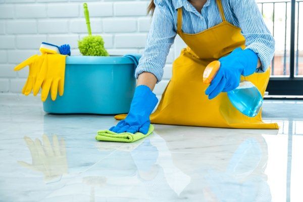 woman-blue-rubber-using-cloth-while-cleaning-floor-home
