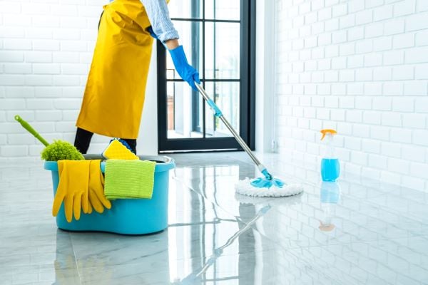 woman-blue-rubber-using-mop-while-cleaning-floor-hom