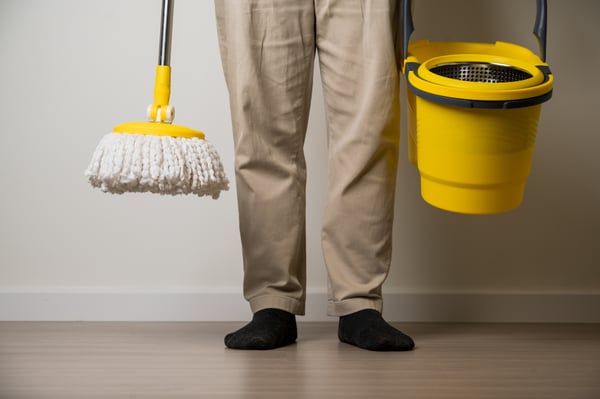 man-standing-holding-yellow-mop-bucket-cleaning-living-room-his-house-home-cleaning-service-concept