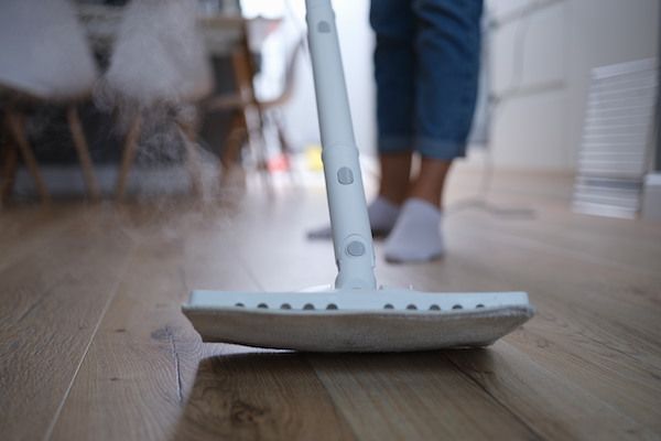 steam-mop-washes-parquet-floor-house