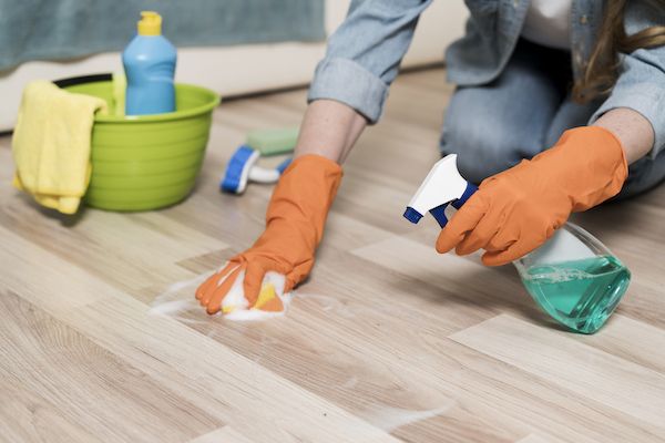 woman-with-rubber-gloves-cleaning-floors (1)